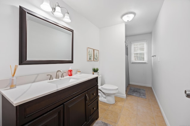 bathroom featuring tile patterned floors, vanity, and toilet