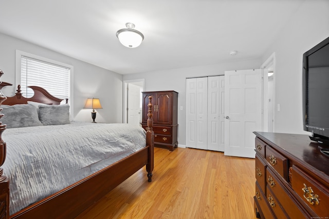 bedroom with a closet and light hardwood / wood-style floors