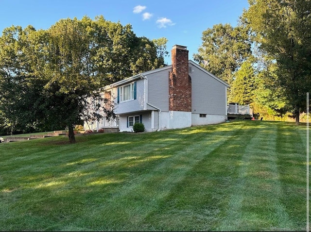 view of side of property featuring a yard