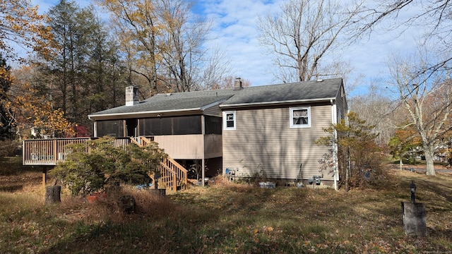 rear view of house featuring a wooden deck