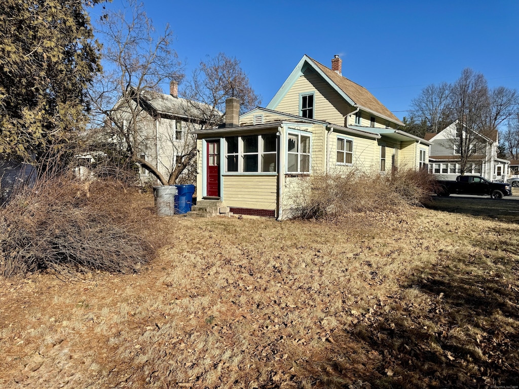 view of property exterior featuring a sunroom