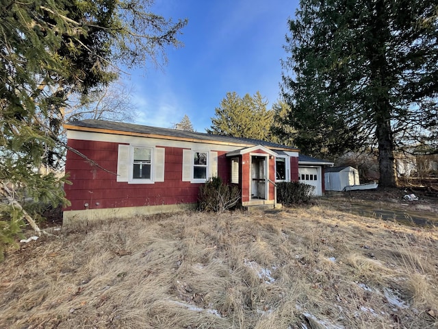 single story home with a shed