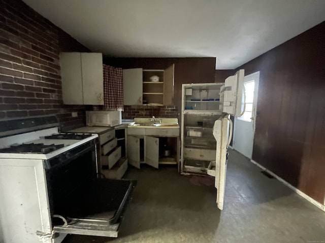 kitchen with white cabinetry and white appliances