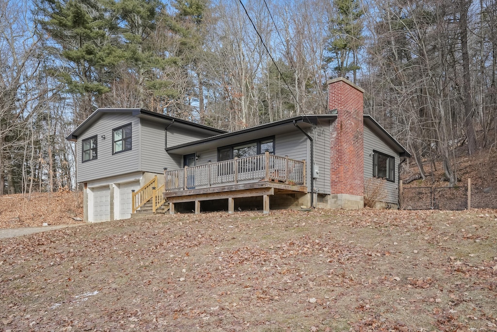 view of front of house with a garage and a deck