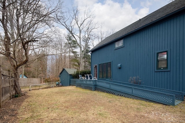 view of yard featuring a storage unit and a deck