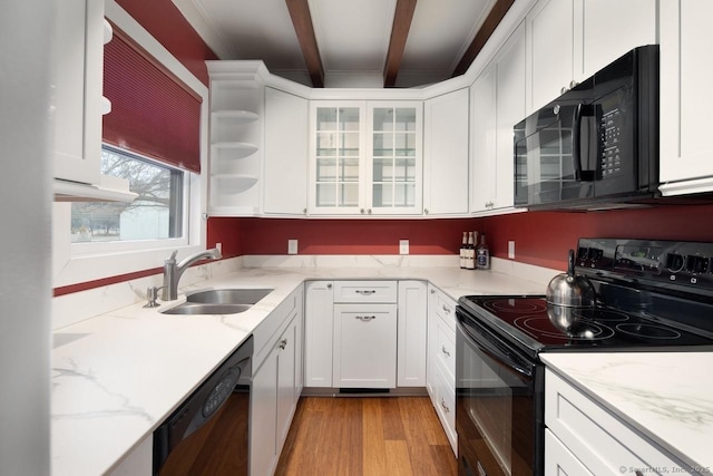 kitchen with white cabinets, sink, beamed ceiling, and black appliances