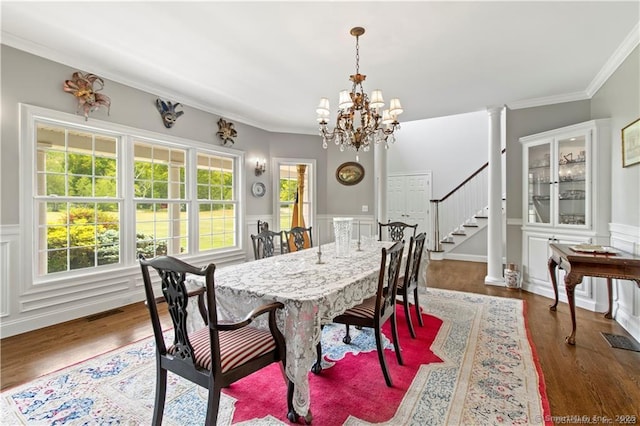 dining room with an inviting chandelier, crown molding, dark hardwood / wood-style floors, and a healthy amount of sunlight