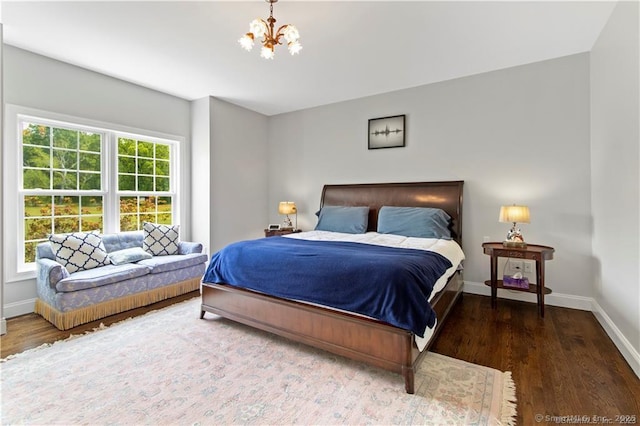 bedroom featuring a chandelier and hardwood / wood-style floors