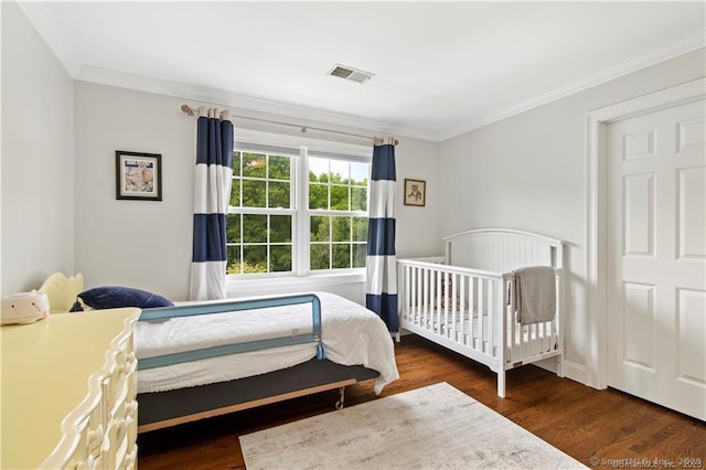 bedroom featuring dark hardwood / wood-style floors and crown molding