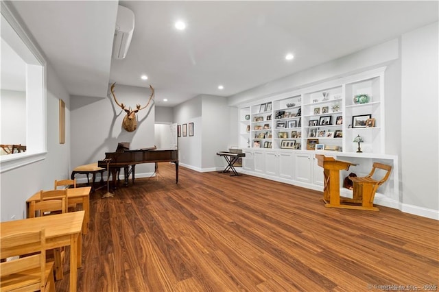 sitting room featuring wood-type flooring and built in features