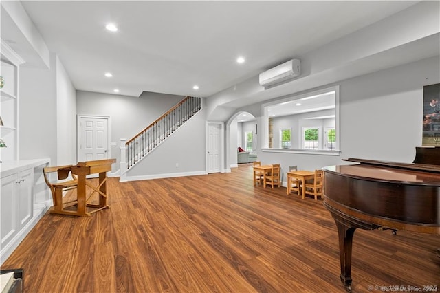 interior space with a wall mounted air conditioner and light wood-type flooring