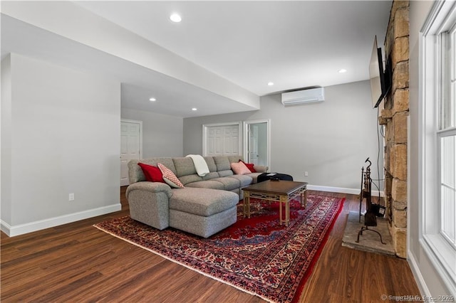 living room with dark wood-type flooring and a wall mounted air conditioner