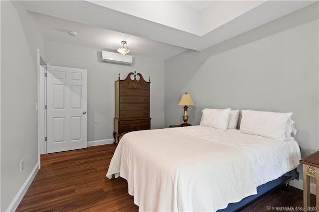 bedroom with a wall mounted AC and dark hardwood / wood-style floors