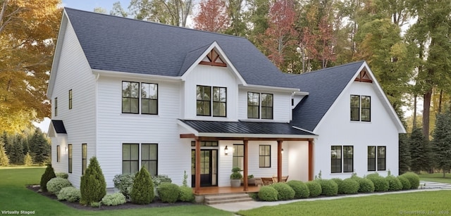 modern farmhouse style home featuring a porch and a front lawn