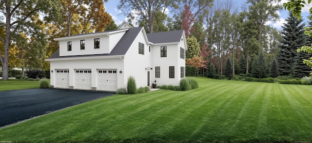 view of property exterior with a yard and a garage