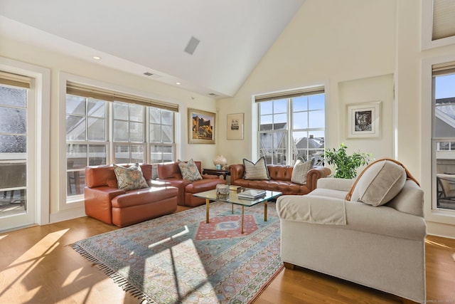 living room with high vaulted ceiling and light hardwood / wood-style floors