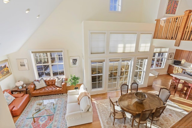 interior space featuring light hardwood / wood-style floors and high vaulted ceiling