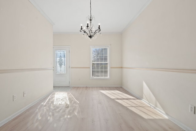 unfurnished dining area featuring crown molding, a notable chandelier, and light wood-type flooring