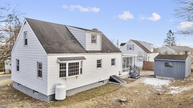 back of house featuring a shed