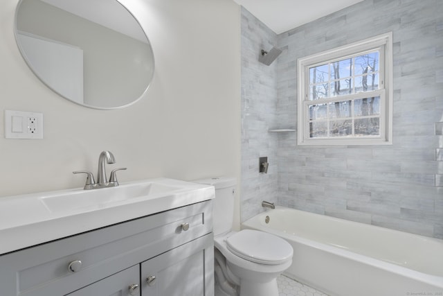 full bathroom with toilet, tiled shower / bath combo, and vanity