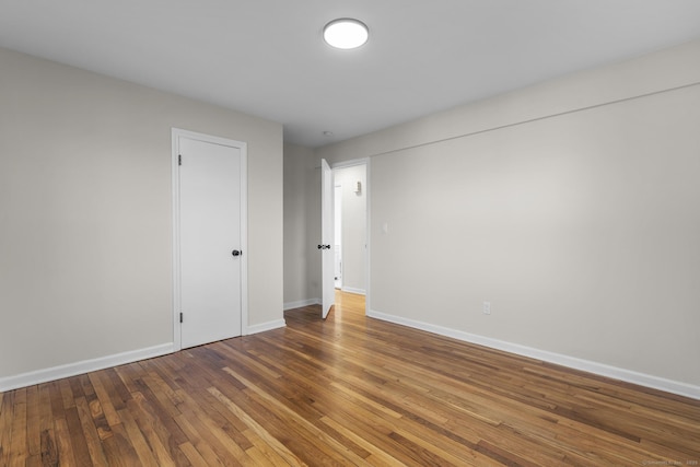 unfurnished room with hardwood / wood-style floors