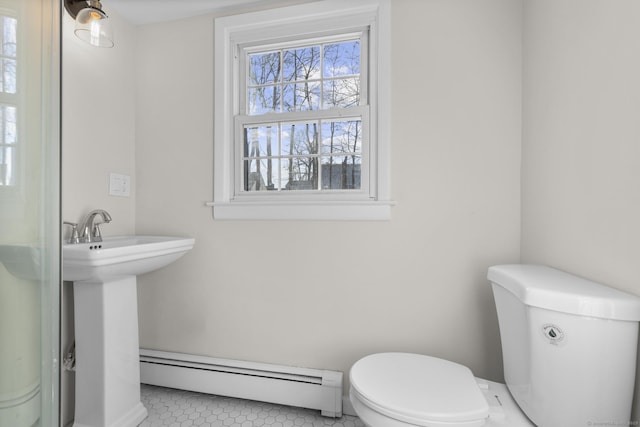 bathroom featuring toilet, a baseboard radiator, and tile patterned flooring