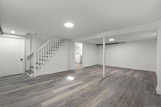 basement featuring dark wood-type flooring and washer / clothes dryer