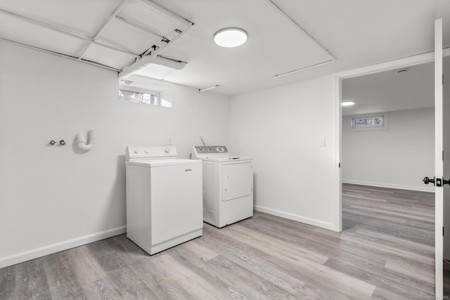 washroom featuring washer and dryer and light wood-type flooring