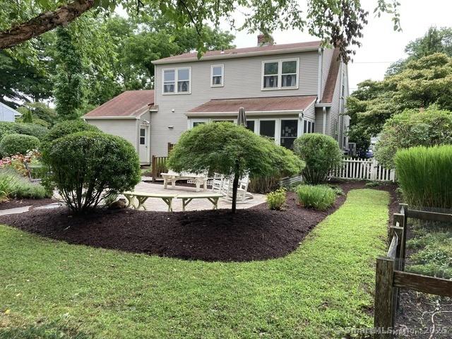 rear view of property with a patio area and a yard