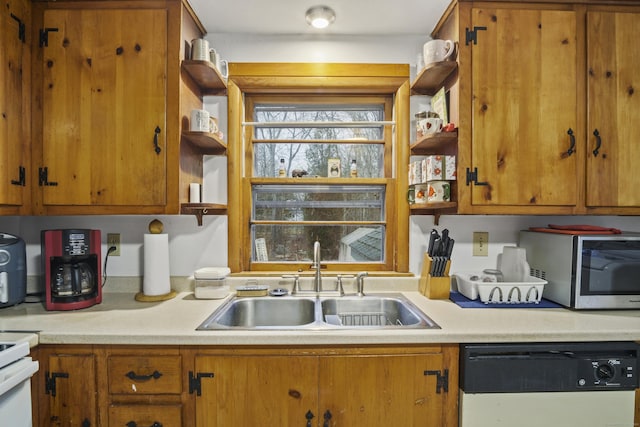 kitchen featuring white dishwasher, range with electric stovetop, and sink