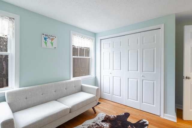 sitting room with a textured ceiling and hardwood / wood-style floors