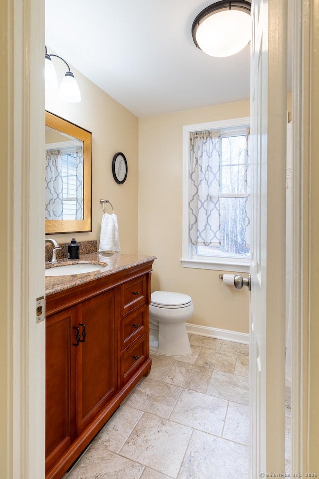 bathroom with toilet and vanity