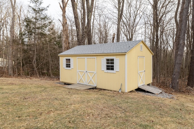 view of outbuilding with a lawn