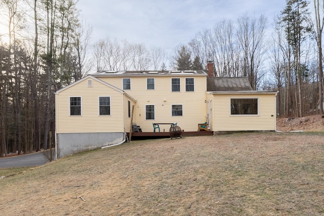 back of property featuring a lawn