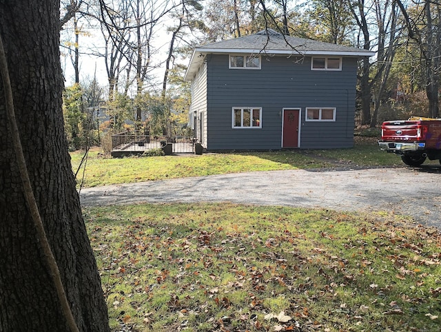 view of side of home with a lawn and a deck