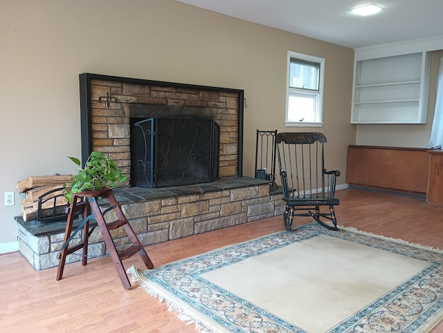 living area with wood-type flooring and a fireplace