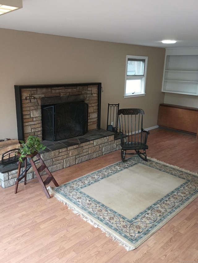 living area with light wood-type flooring and a fireplace