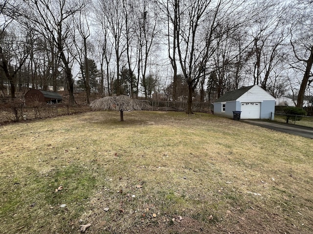 view of yard with a garage and an outdoor structure