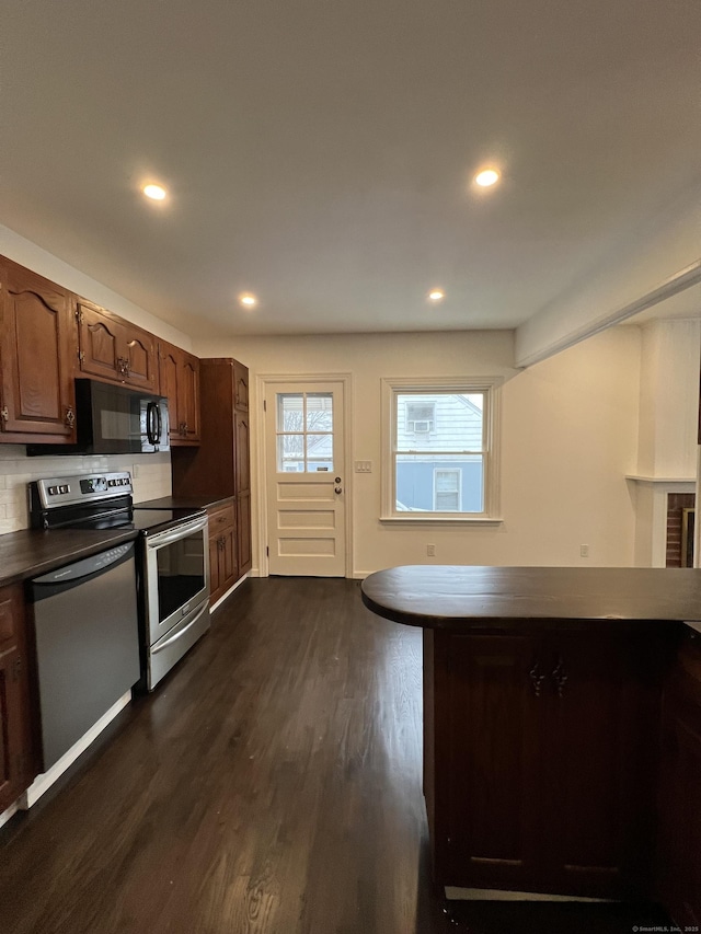 kitchen with dark hardwood / wood-style flooring and stainless steel appliances