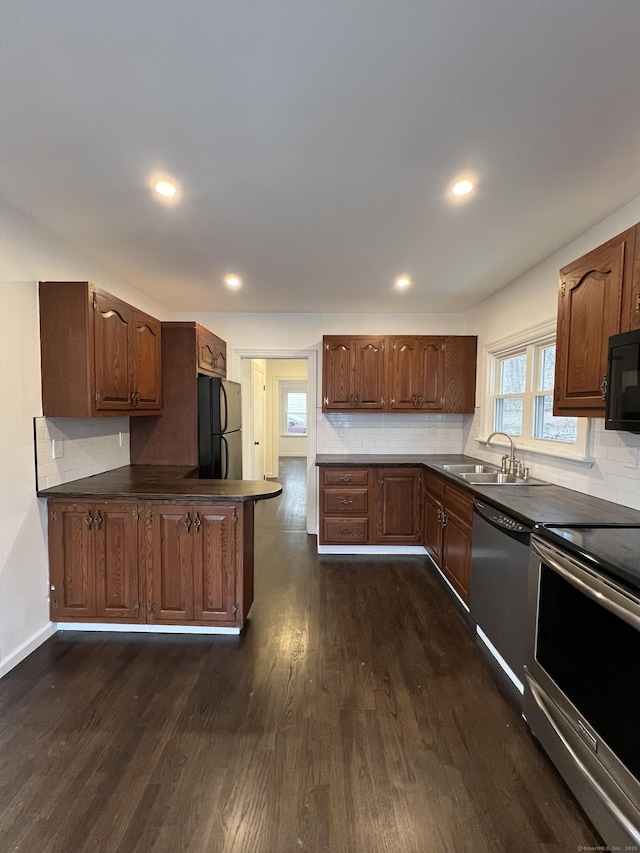 kitchen featuring dark hardwood / wood-style flooring, sink, a healthy amount of sunlight, and black appliances