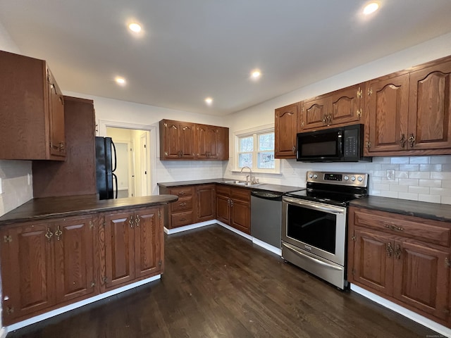 kitchen featuring dark hardwood / wood-style flooring, sink, tasteful backsplash, and black appliances