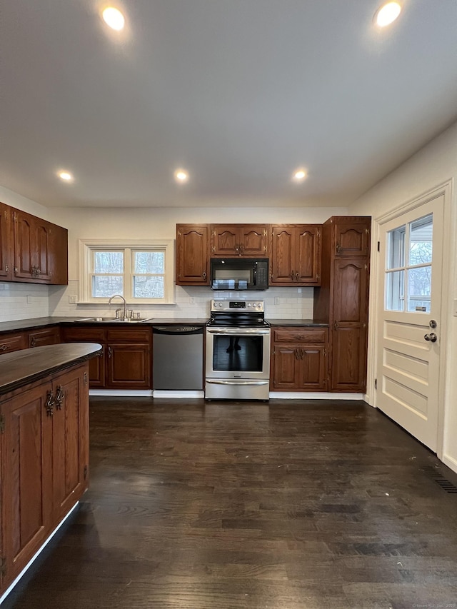 kitchen featuring backsplash, a healthy amount of sunlight, and stainless steel appliances