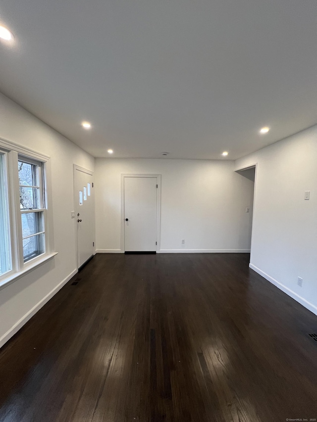 empty room with dark wood-type flooring