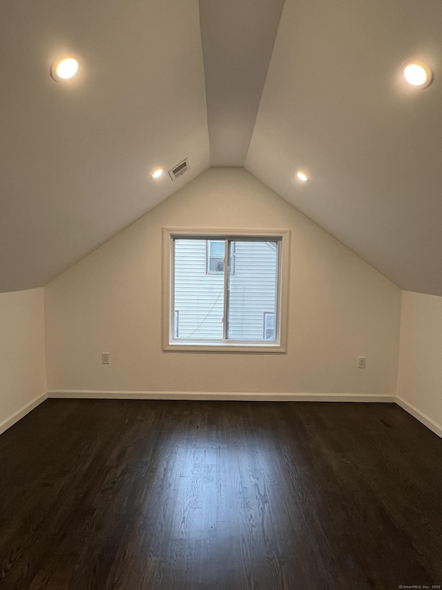 bonus room featuring dark hardwood / wood-style floors and lofted ceiling