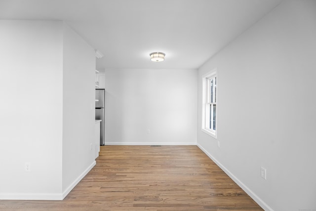 spare room featuring light hardwood / wood-style floors