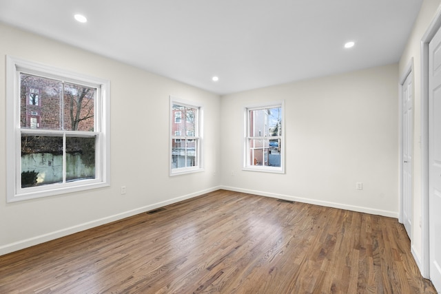 unfurnished bedroom with hardwood / wood-style floors