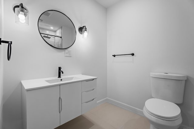 bathroom featuring tile patterned floors, vanity, and toilet