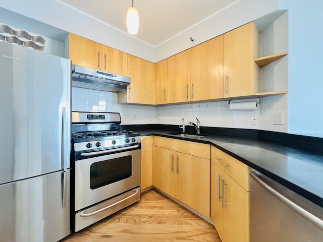 kitchen featuring light brown cabinets, sink, tasteful backsplash, light hardwood / wood-style floors, and stainless steel appliances