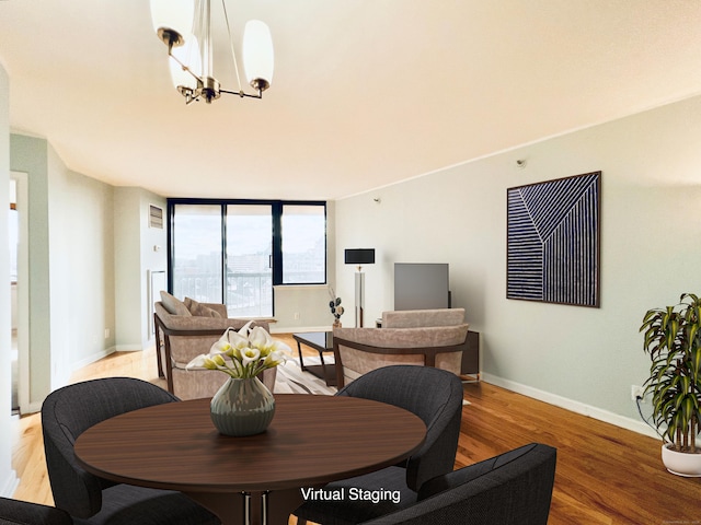 dining area featuring light wood-type flooring and an inviting chandelier