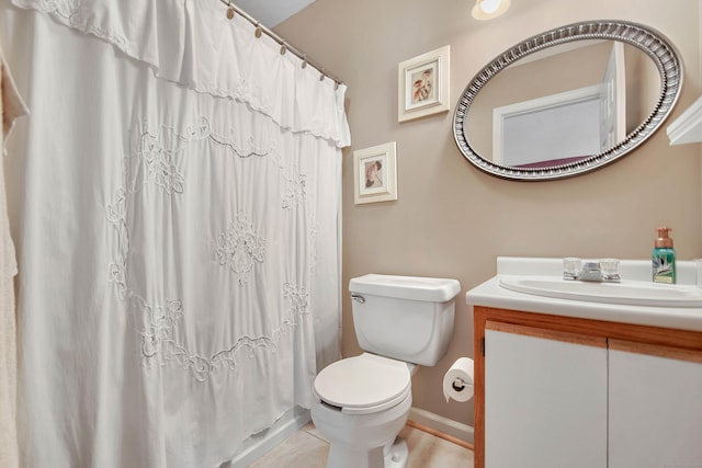 bathroom featuring a shower with curtain, tile patterned flooring, vanity, and toilet